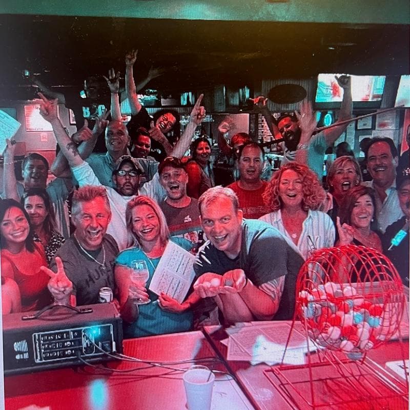A group of guests cheering at Jack's Seafood Bar & Grill in North Naples